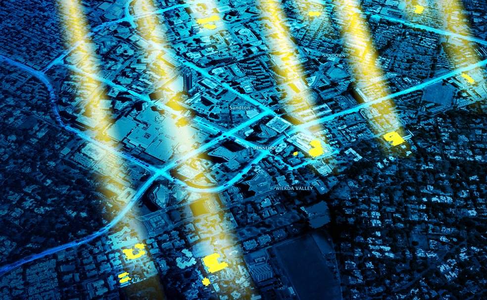 A night aerial view of Sandton, with commercial rooftops lit up as geo-precise solar leads, brighter where the opportunity is.